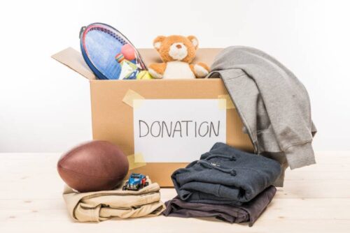 Donation box filled with toys, clothes, and sports equipment for MyTee Movers community giving program.